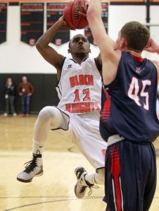 Jordan Saylor scores against Austin Katstra in the Jefferson District Titel Game. 